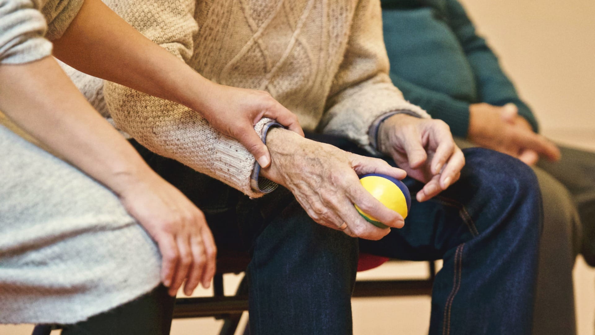 senior grabbing ball with nurse | HealthCare.com